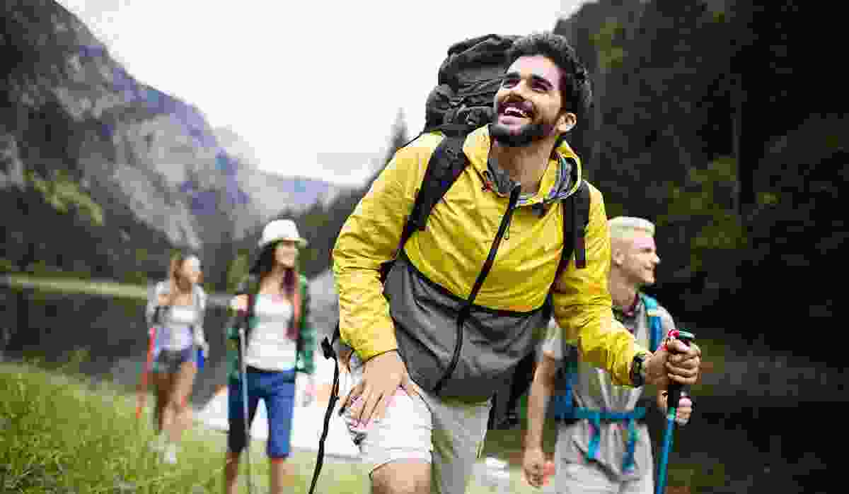 A happy family hiking in a splendid river valley in Colombia