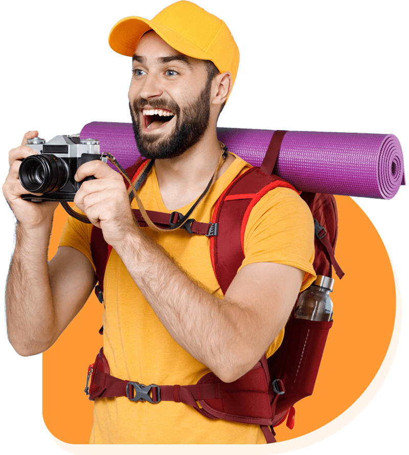 excited single Western man with camera and backpack on deep forest hike