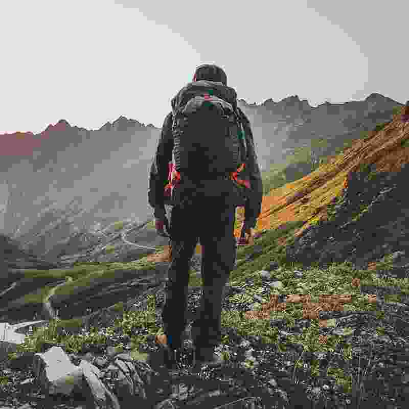 Solo man wandering into the mountains for adventure.