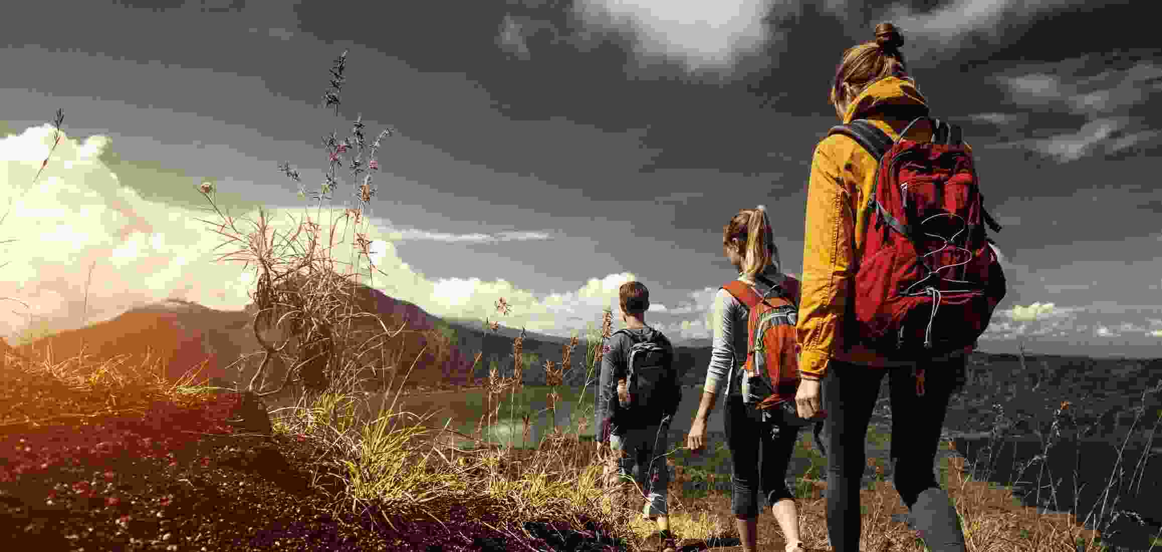 Two hiking women and a man head to a secluded area near a lake for some fun.