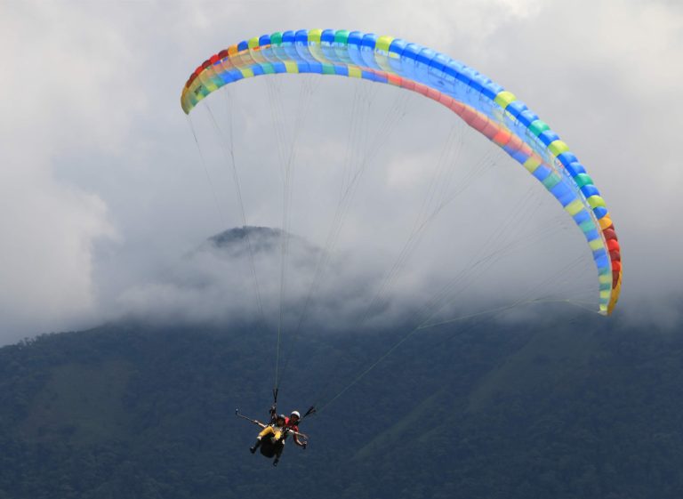 Paragliding over mountain peaks in Colombia.