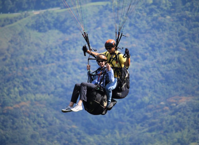 Tandem paragliding flight over Colombia’s valleys.