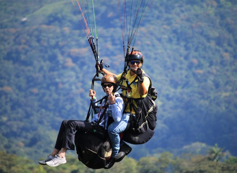 Tandem paragliding flight over Colombia’s mountain.